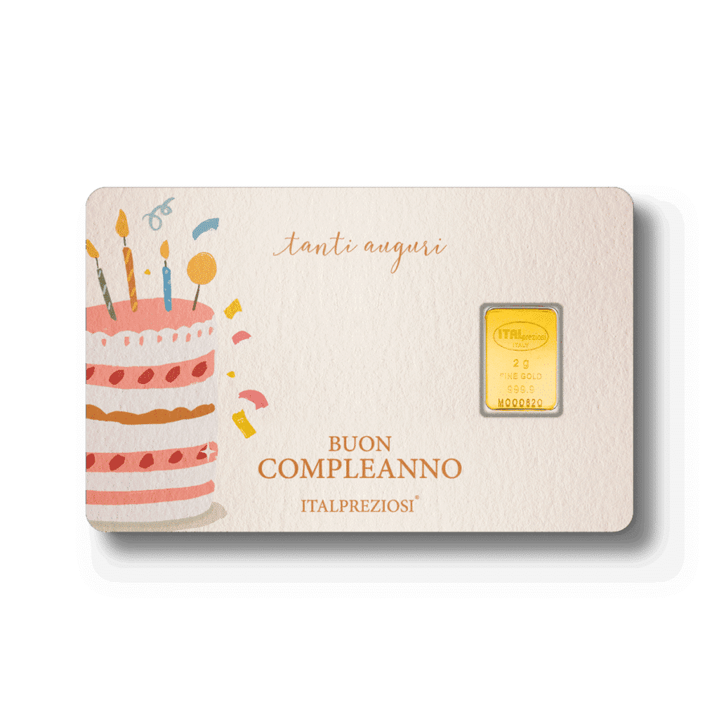 Compleanno: un biglietto di compleanno con una torta illustrata, candeline, coriandoli vivaci, le frasi "tanti auguri" e "Buon Compleanno" e un piccolo lingotto d'oro incastonato sul lato destro.