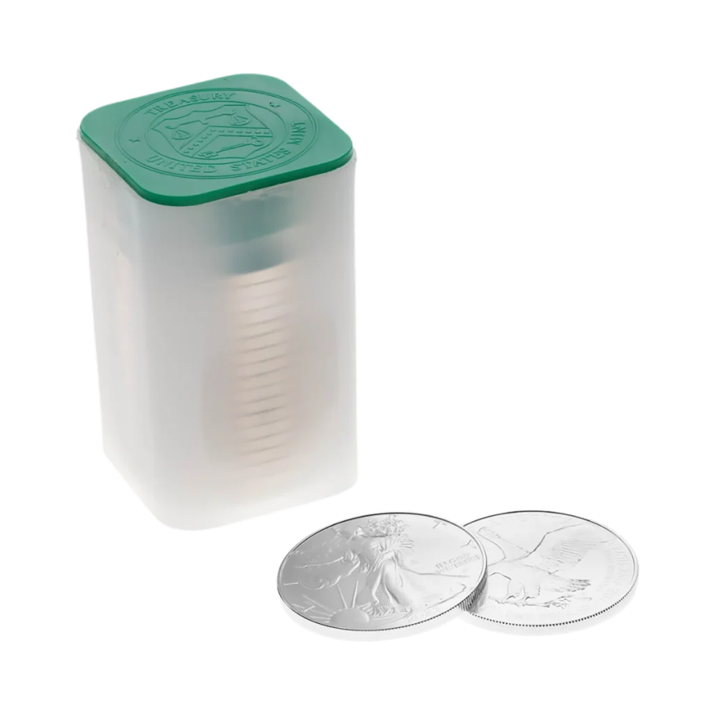 A translucent tube with a green lid holds Silver American Eagle coins, with two Silver American Eagle coins beside it displaying their intricate designs.