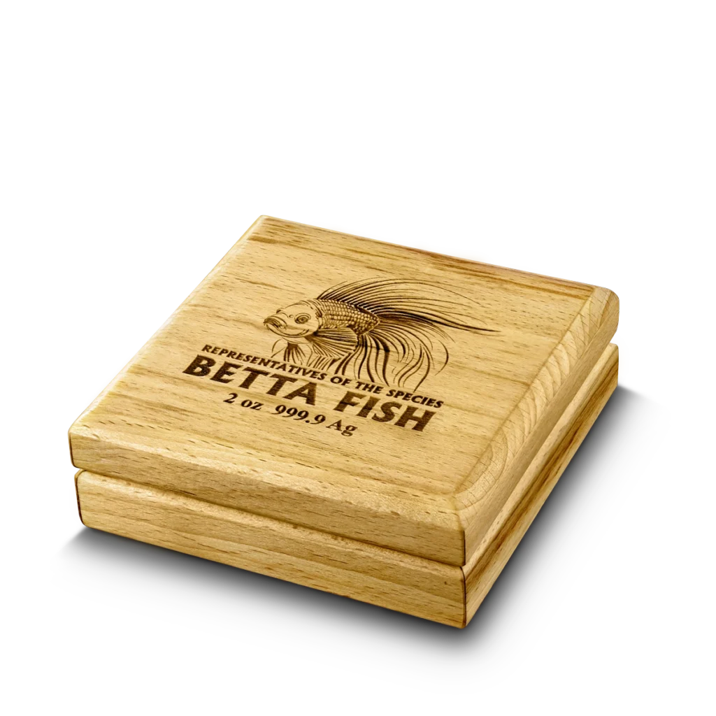 A square wooden box with an engraved betta fish and “Niue Island 2024 Betta Fish 2 oz Silver High Relief, 999.9 Ag” on the lid.
