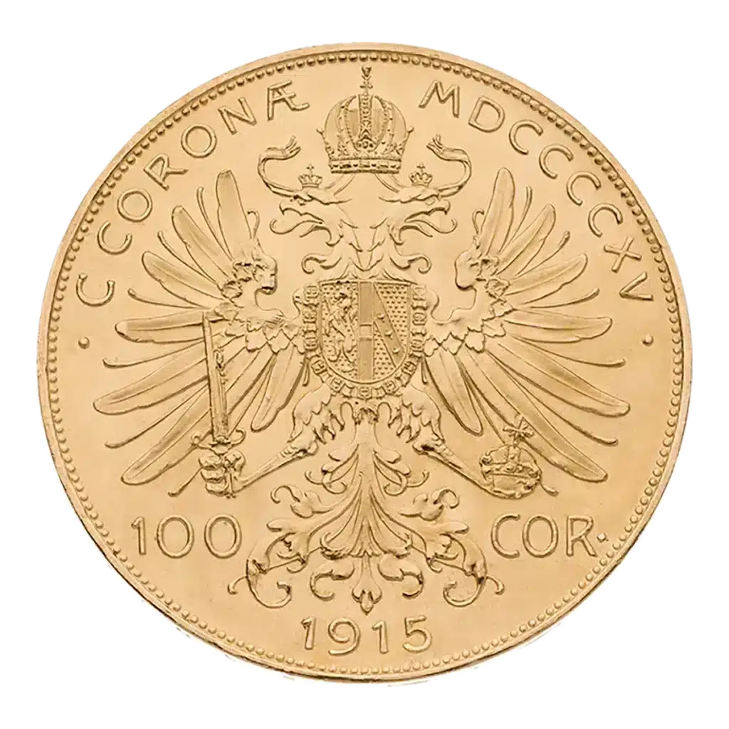La moneda de oro 100 Corona Austria muestra un águila bicéfala con las alas extendidas, corona, cetro y escudo. En el canto puede leerse "C. CORONA MDCCCCXV", con "100 COR" y la fecha "1915" debajo.