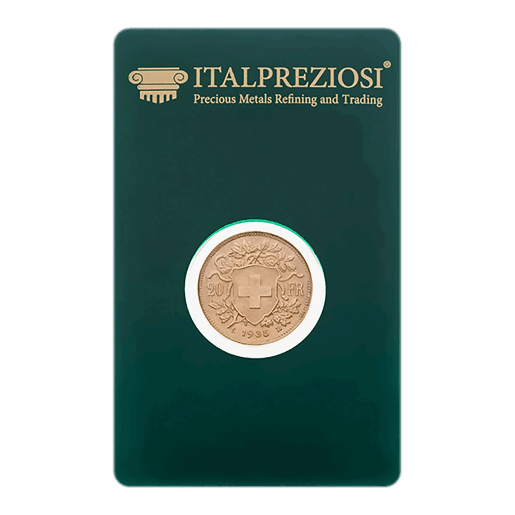La moneta d'oro Marengo, caratterizzata da una croce svizzera e da un disegno floreale, è esposta in un astuccio verde scuro a marchio Italpreziosi per la raffinazione e il commercio dei metalli preziosi.