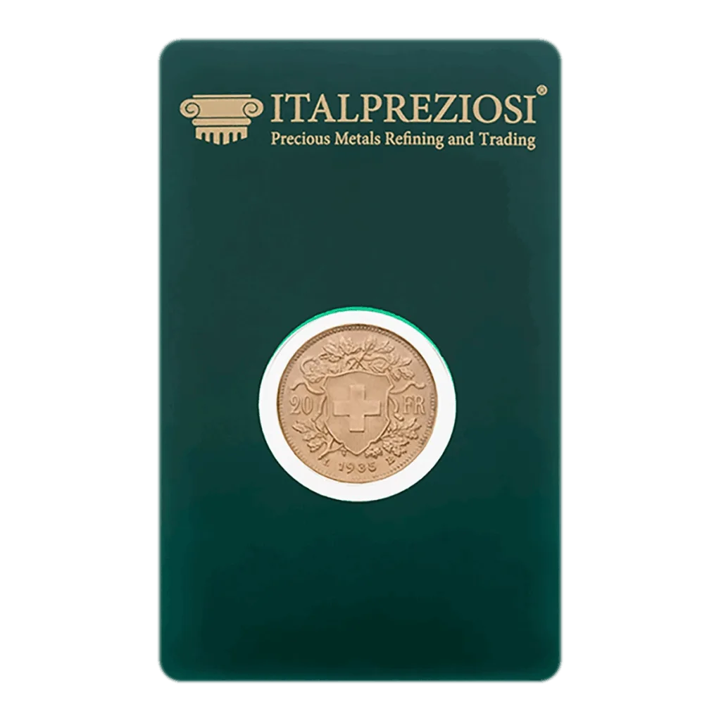 La moneta d'oro Marengo, caratterizzata da una croce svizzera e da un disegno floreale, è esposta in un astuccio verde scuro a marchio Italpreziosi per la raffinazione e il commercio dei metalli preziosi.
