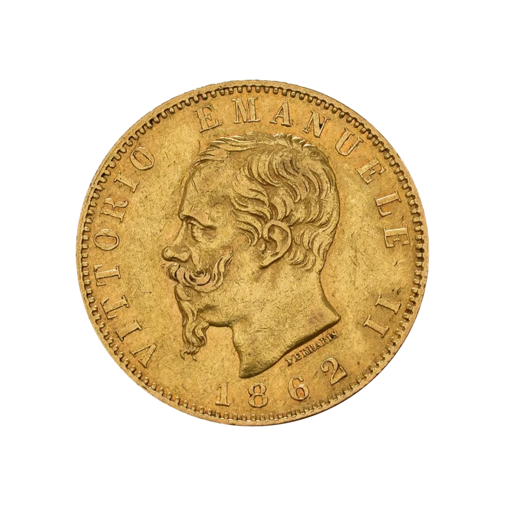 La moneda de oro de Marengo muestra el perfil de un hombre barbado mirando hacia la derecha, con la inscripción "VITTORIO EMANUELE II" alrededor del borde y la fecha de 1862 en la parte inferior.