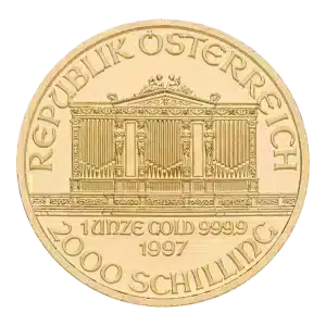 La moneda de oro de la Filarmónica de Viena muestra la inscripción "REPUBLIK ÖSTERREICH" sobre un edificio ornamentado, con la inscripción "1 UNZE GOLD 999.9 1997" y la denominación "2000 SCHILLING" debajo.