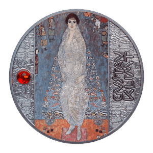 La moneda de 500 francos CFA "Retrato de la Baronesa Elisabeth Bachofen-Echt - Gustav Klimt" muestra un cuadro de una mujer vestida de blanco, el nombre de Klimt a la derecha y una gema roja engastada a la izquierda.