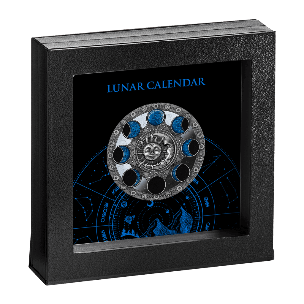 Calendario Lunar 2 Dólares presenta una caja expositora de marco negro con un calendario lunar circular, fases lunares, cara central del sol y símbolos del zodíaco sobre un fondo azul y negro con la leyenda "CALENDARIO LUNAR" en la parte superior.