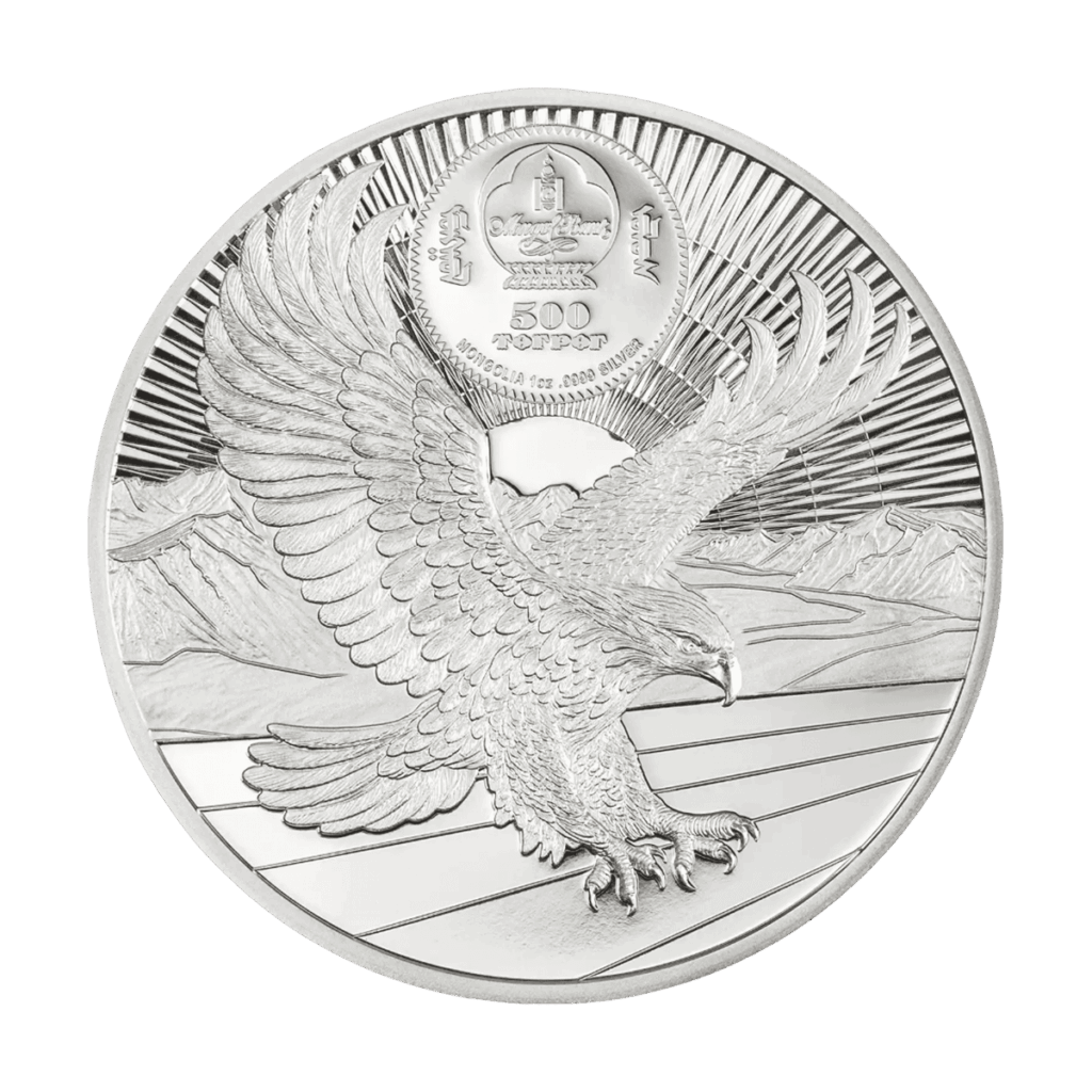 Retro della moneta da collezione "Gengis Khan" Italpreziosi in argento della Mongolia da 500 Tögrög, 1oz d'argento .9999. Incisione ad alto rilievo di un'aquila reale in volo con ali spiegate, su sfondo di raggi solari e paesaggio montuoso. Stemma della Mongolia con iscrizione in scrittura mongola tradizionale in alto al centro.