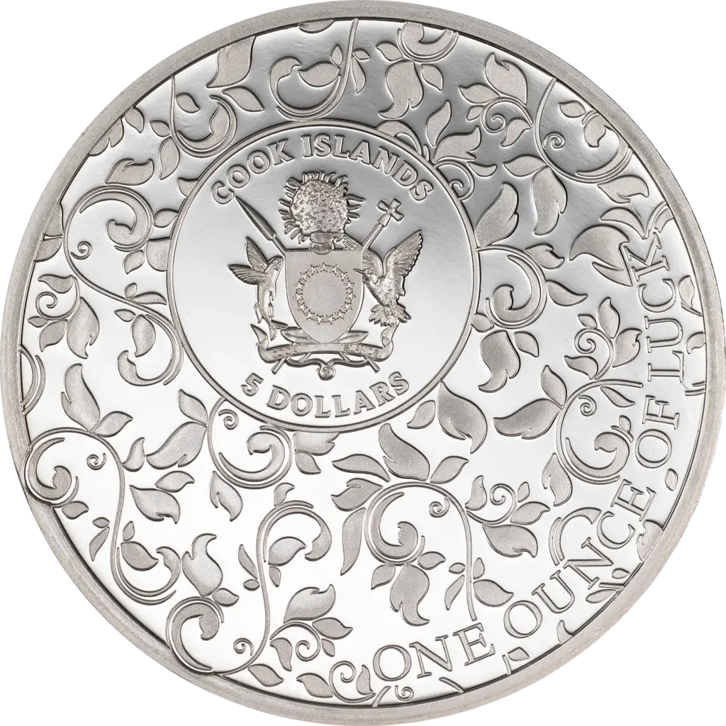 Dritto della moneta Ounce of Luck 2026 in argento: stemma delle Isole Cook al centro di un medaglione, circondato da tralci e foglie in rilievo, con le scritte COOK ISLANDS, 5 DOLLARS e ONE OUNCE OF LUCK.