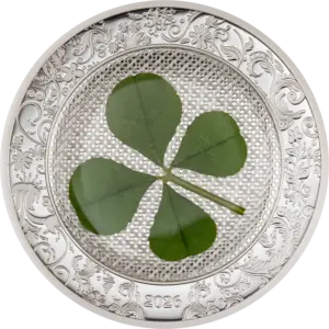 La moneta Ounce of Luck 2026 da 1 oz in argento 999.9 proof racchiude un vero quadrifoglio verde su un fondo lavorato a rete, incorniciato da un bordo con decori floreali in rilievo e l'anno 2026.