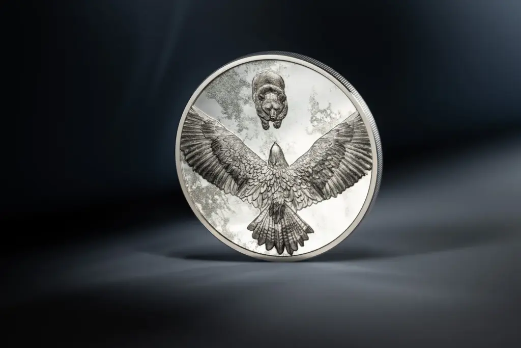 Seven Deadly Sins - Envy coin against a dark background with light reflections, on the side with the eagle's outspread wings.