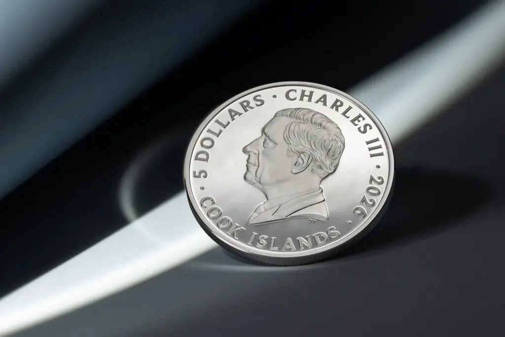 Seven Deadly Sins - Envy coin tilted against a dark background crossed by a streak of light, on the side with the effigy of Charles III.